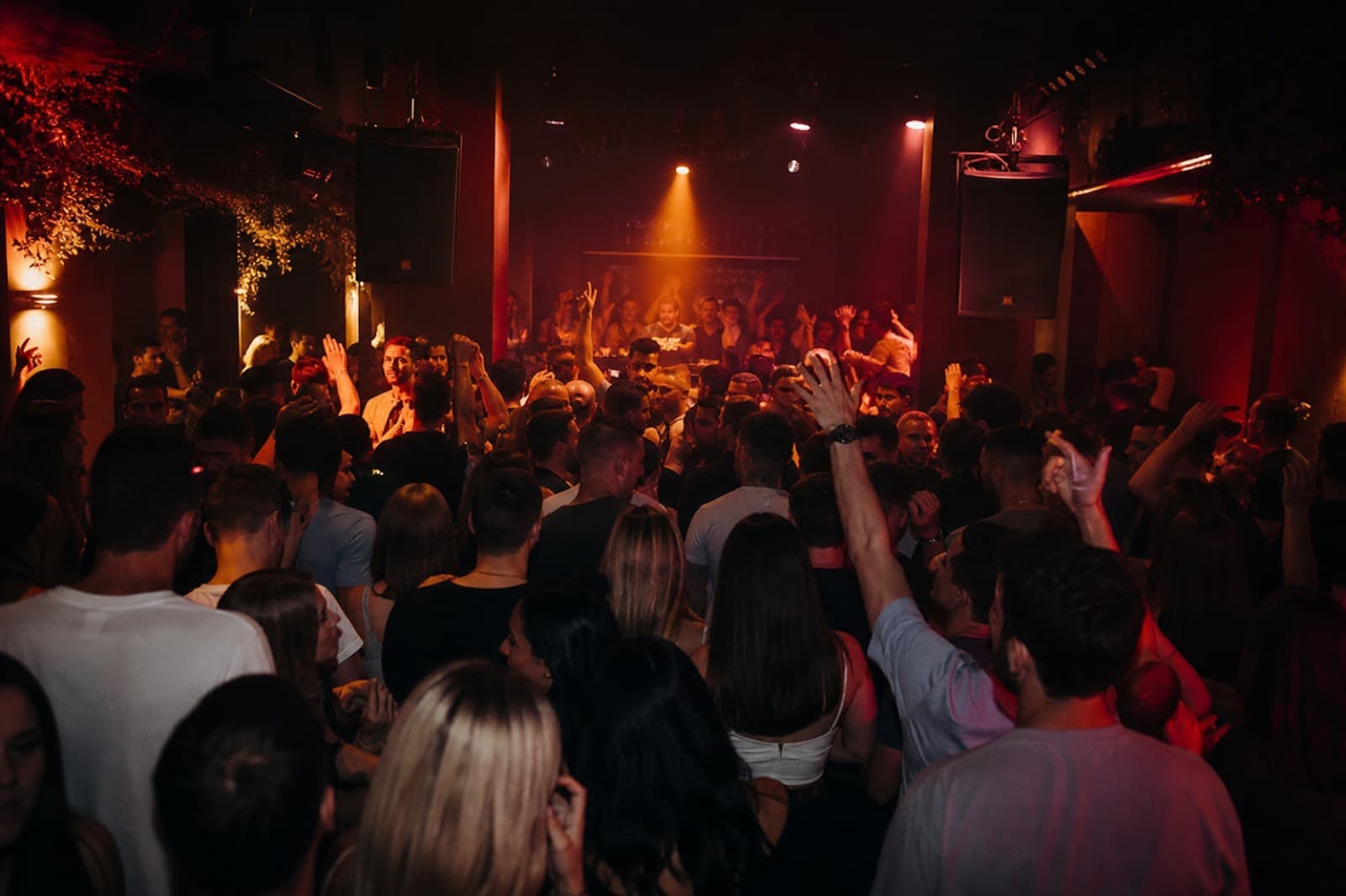 Crowd and DJ booth at a rave
